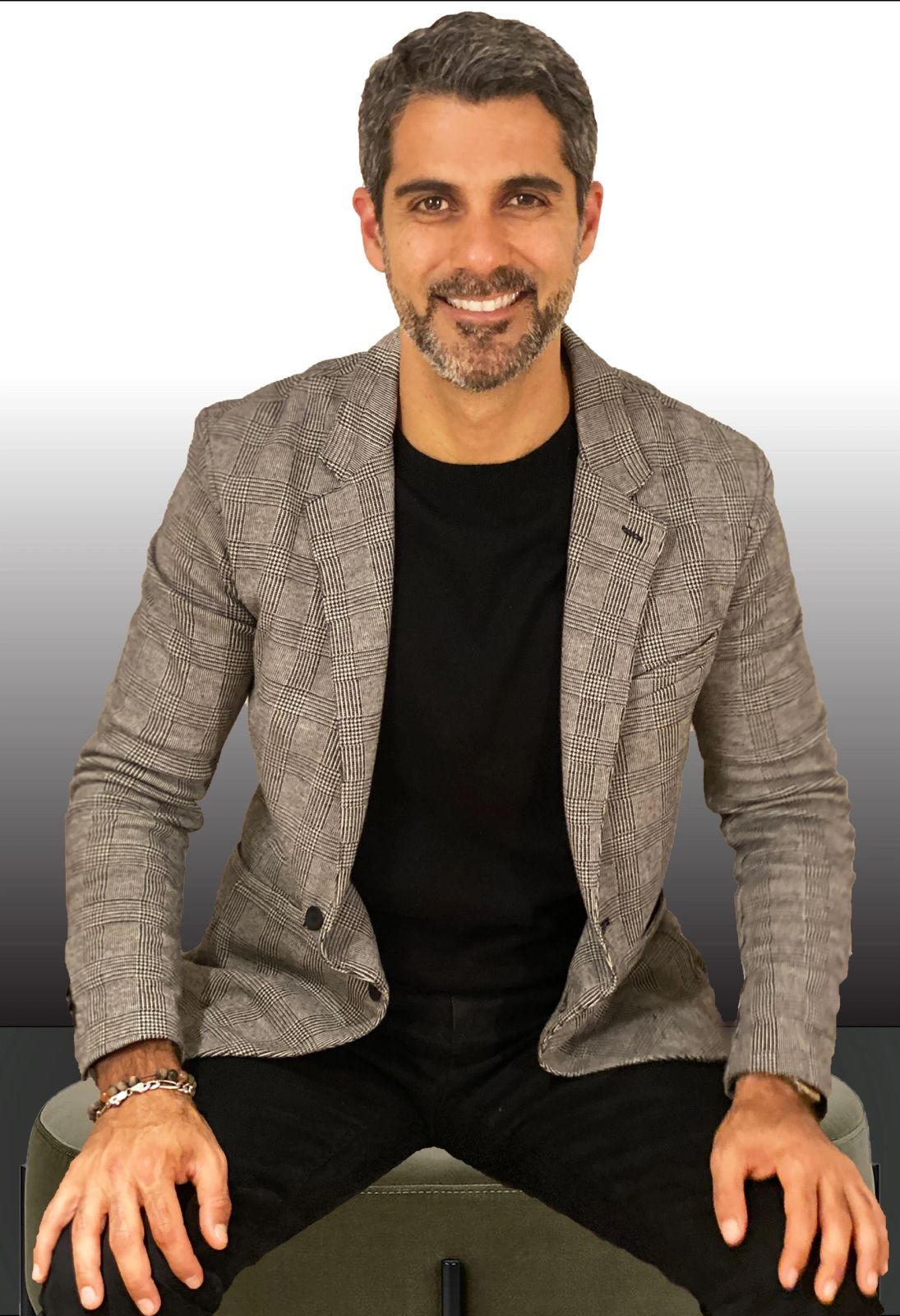 Hamada Zahawi seated in a checked blazer